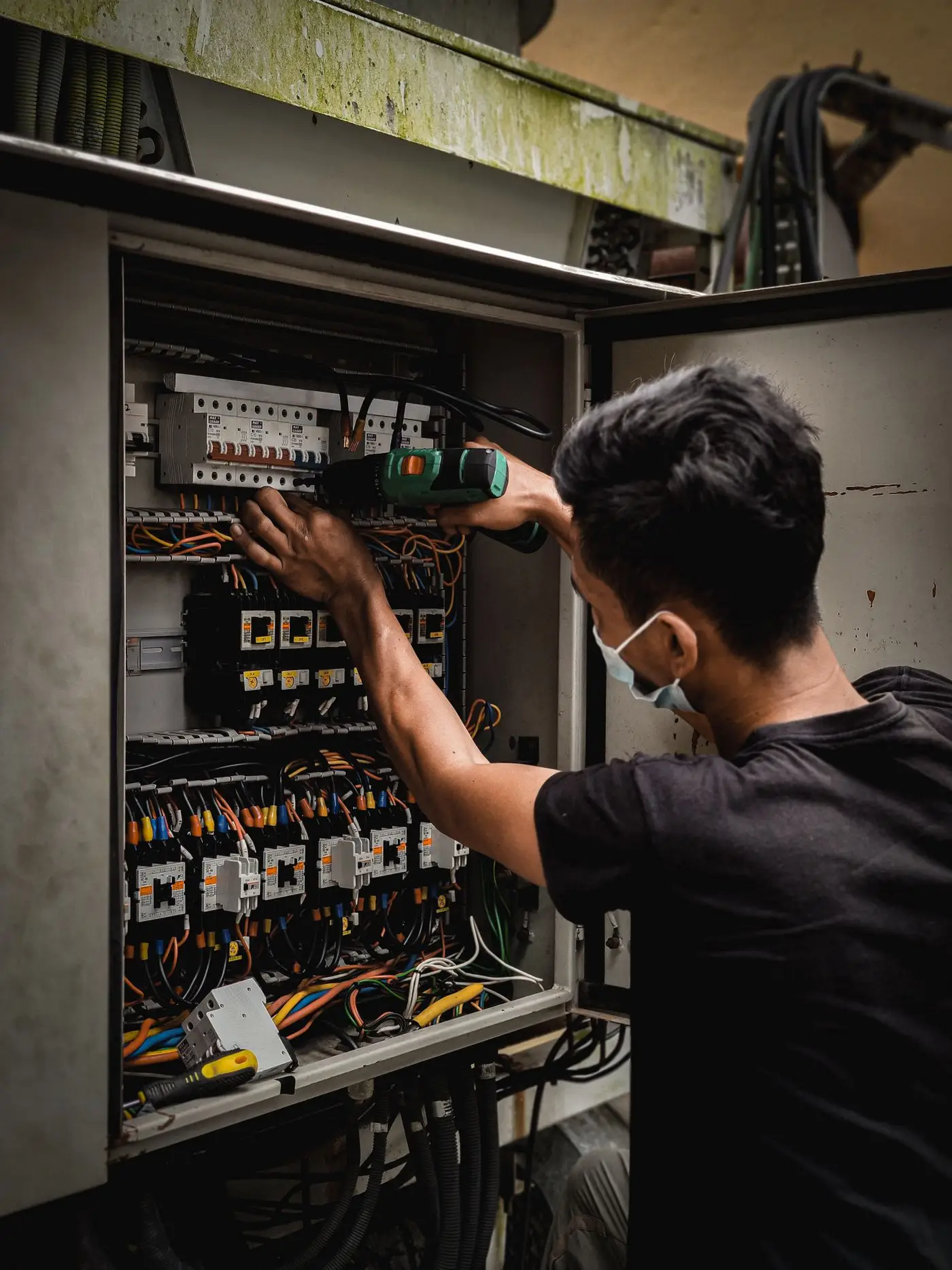 A technician working on a circuit breaker switch