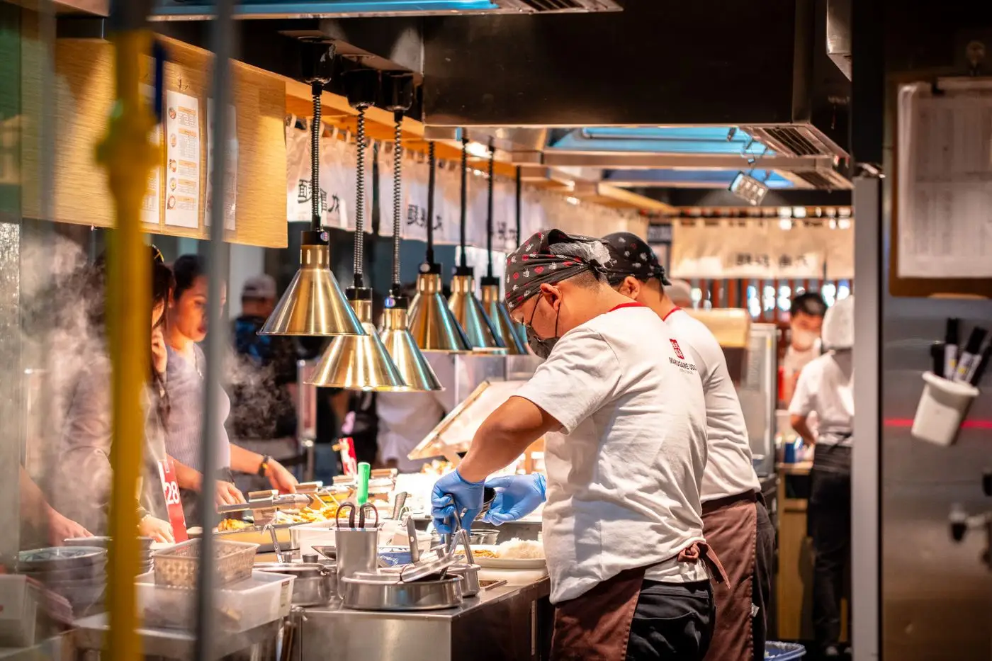A chef team mid-service in a busy restaurant kitchen