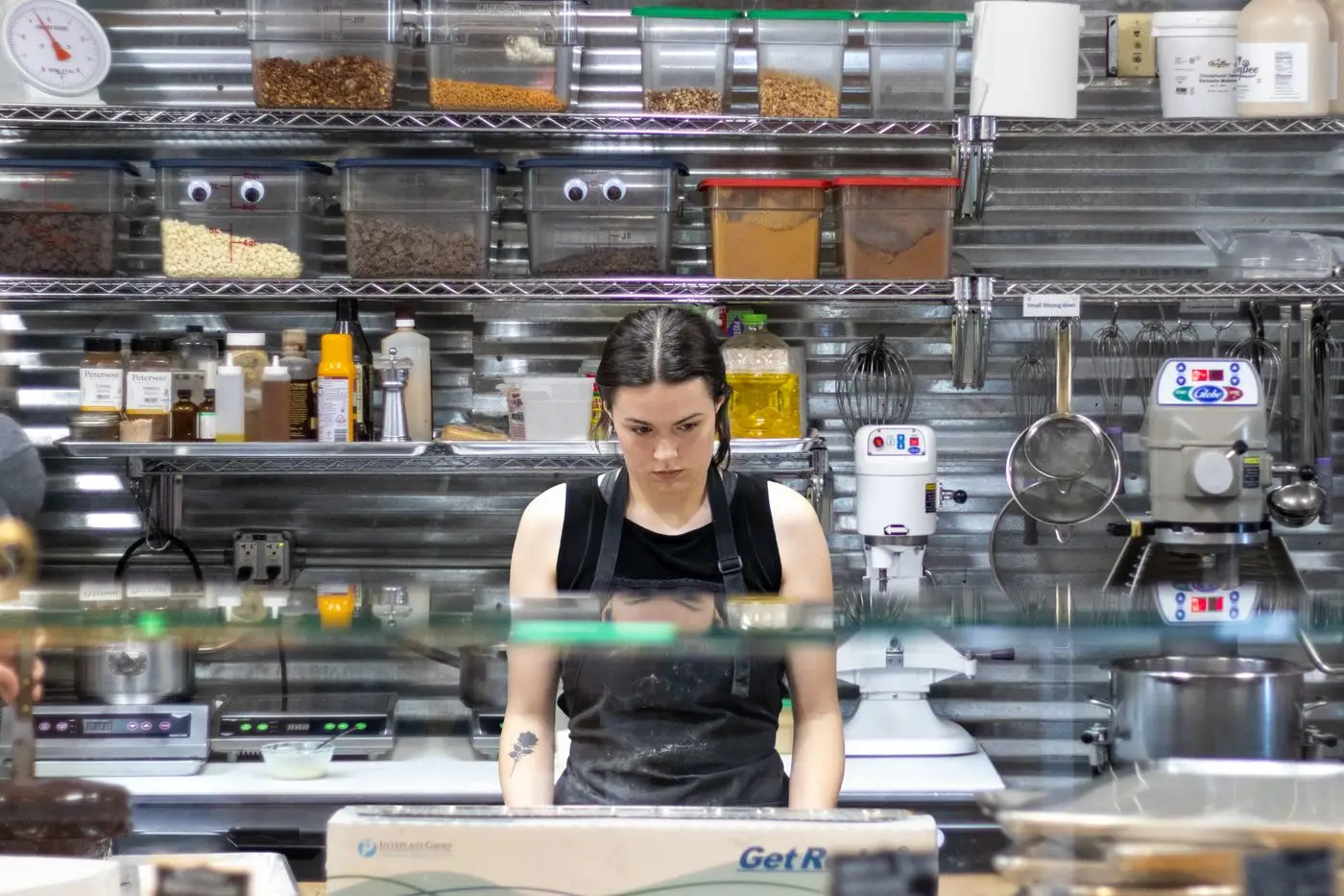 A cook working a commercial kitchen counter during service
